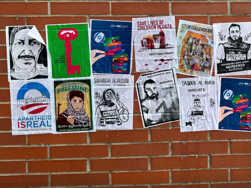Flyers in support of Palestine posted on the side of the bookstore.