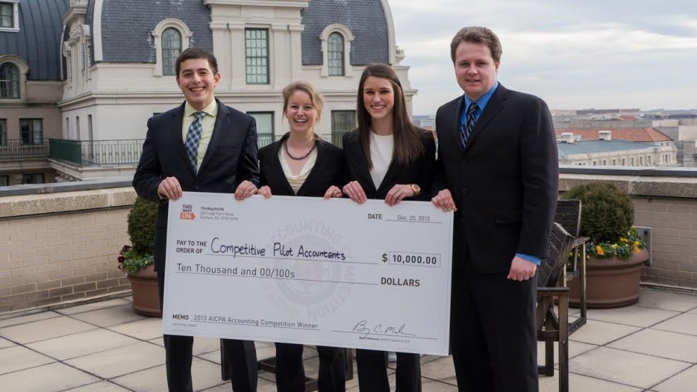  (from left) Seniors Tyler Desmarais, Ingrid Nelson, Michelle Siegal and Marton McMahon show off their $10,000 prize from winning the American Institute of Certified Public Accountants’ (AICPA) annual competition. The UP team beat 145 other teams competing in the Washington D.C. competition.Photo courtesy of AICPA