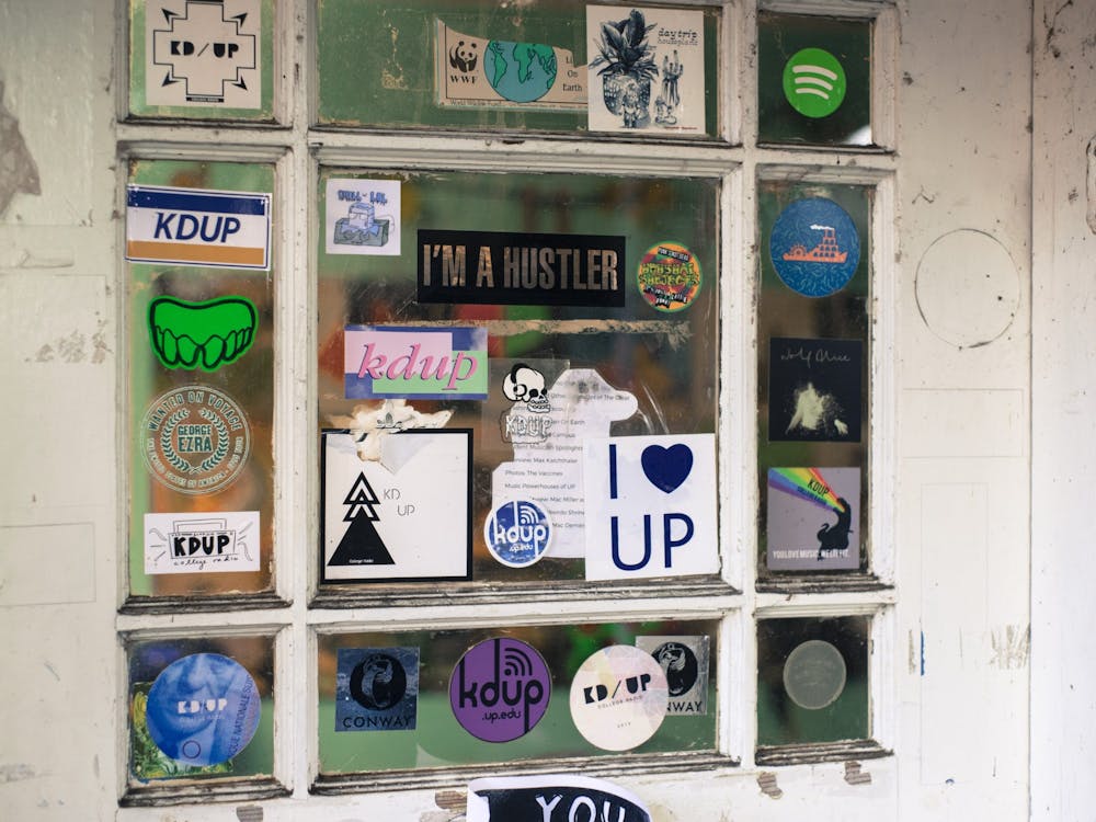 The front door of The Shack, KDUP&#x27;s recording and broadcasting studio, is littered with stickers from throughout the years.