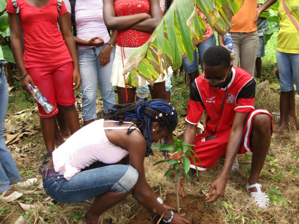 This is a photo of Dr. Oculi helping a community member plant a tree. He was doing so as part of their &quot;Propagating Peace&quot; project.Photo courtesy of Neil Oculi