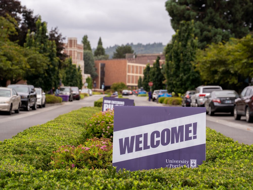 A University of Portland "welcome" sign at the main entrance to the campus.