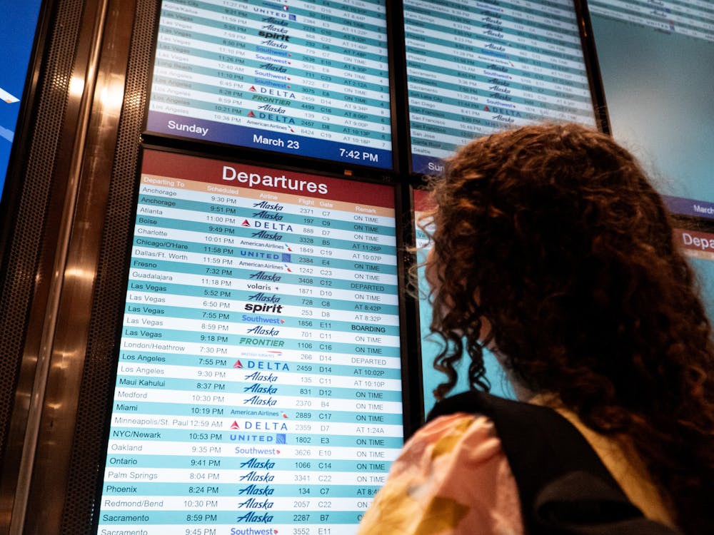 A person checks a departures board at an airport. A funding freeze has thrown the futures of thousands of U.S. college students into uncertainty, as the State Department paused all disbursements for Fulbright and Gilman Scholarship recipients.