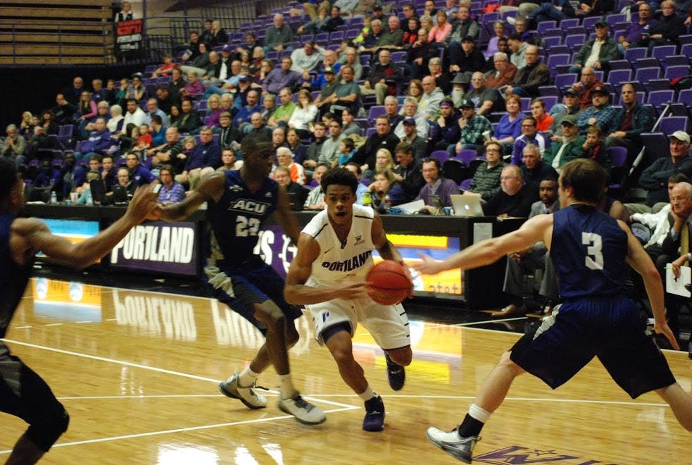  Rashad Jackson drives to the hoop against an ACU defender. Photo by David DiLoreto