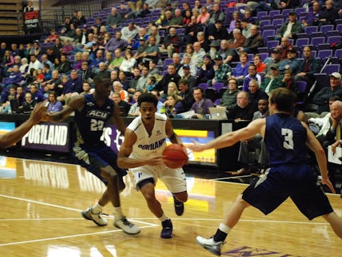  Rashad Jackson drives to the hoop against an ACU defender. Photo by David DiLoreto