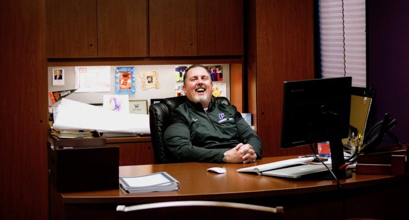 Leykam laughs at his desk in his office in the Chiles Center.
