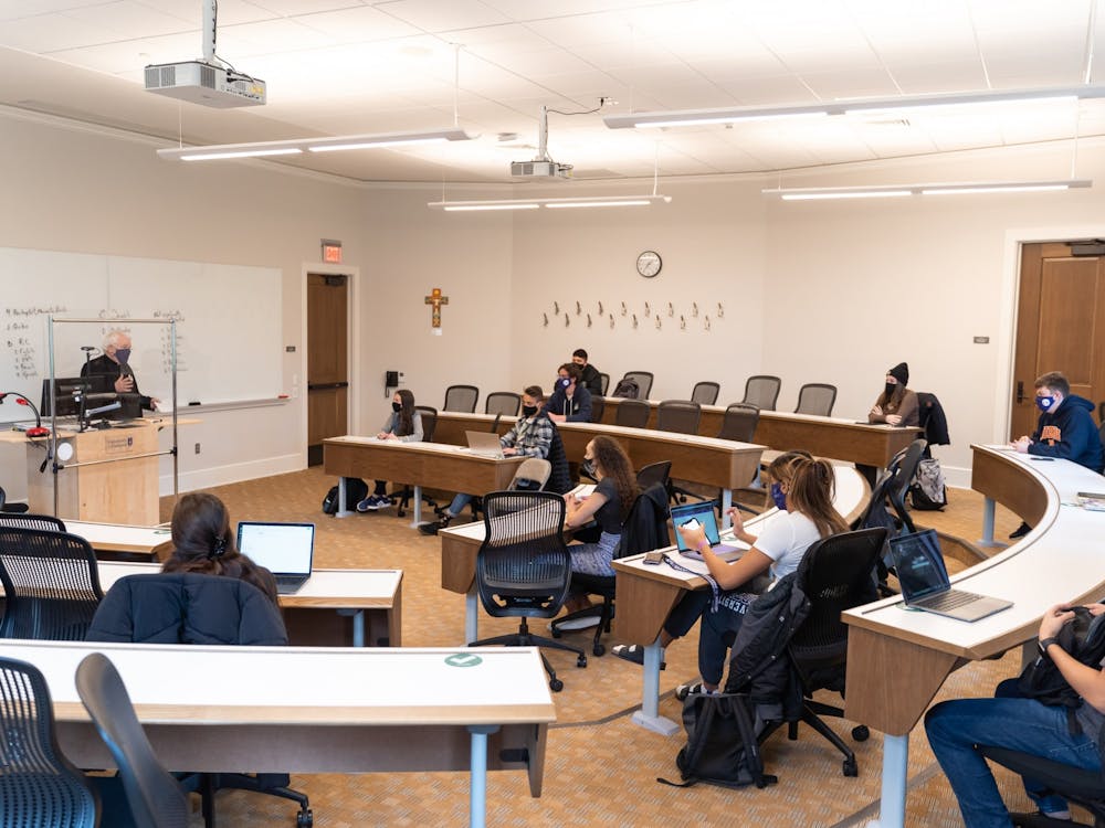 Fr. Art Wheeler was one of many volunteers to teach an in-person class this semester. Students are masked and socially distanced in the classroom. 