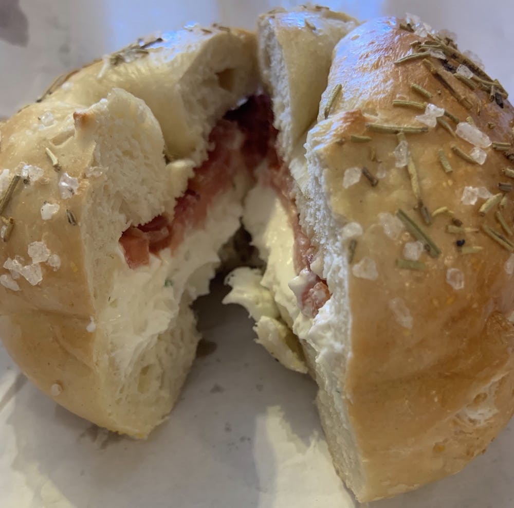<p>A rosemary sea salt bagel from Nate's Bagels in Richmond, Virginia, topped with scallion cream cheese, tomato and bacon. <em>Photo courtesy of Holly Lundeen</em></p>