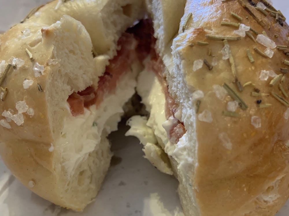 A rosemary sea salt bagel from Nate's Bagels in Richmond, Virginia, topped with scallion cream cheese, tomato and bacon. Photo courtesy of Holly Lundeen