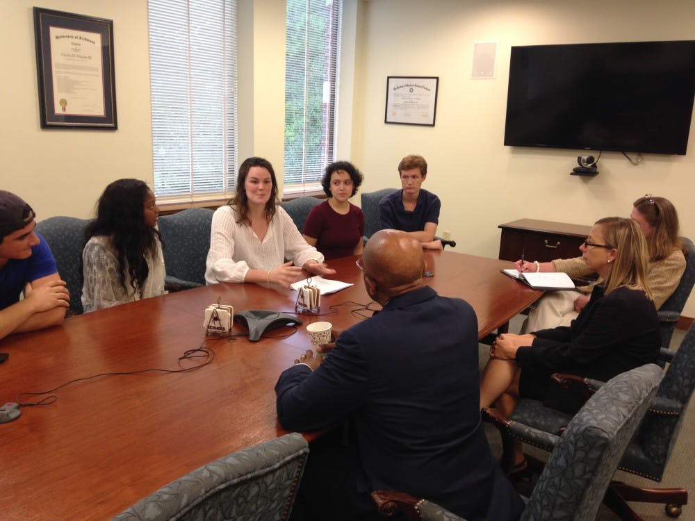 President Crutcher sits down with members of SASAV, including Harrison, who is pictured addressing Crutcher.