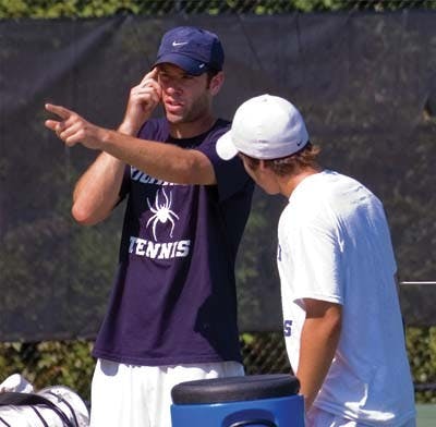 New Men's Tennis coach Billy Boykin giving freshman Chester Murray some pointers while Rafa Arana, '11, prepares to return a serve in the background. 