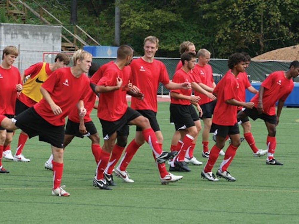 The Men's Soccer team stretching together.