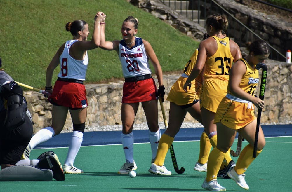 <p>Sophomore forward Clara Larripa high-fiving junior midfielder Jess McMeeking after a goal attempt.&nbsp;</p>