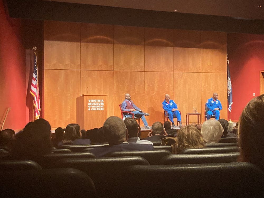<p>Former astronaut Leland Melvin, ‘86, and Robert Satcher during talk at VMHC on Oct. 25.&nbsp;</p>