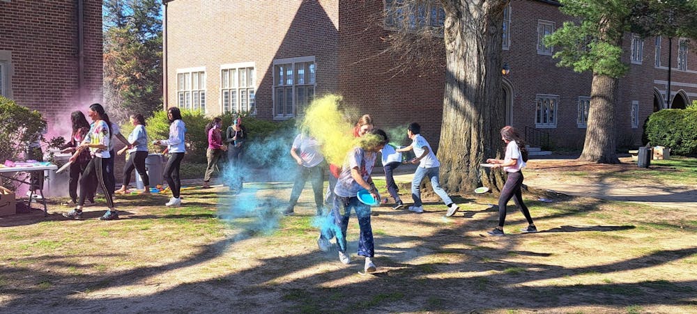 <p>Students celebrate Holi by throwing powdered colors at one another in a friendly game on March 19 at the Westhampton Green.&nbsp;</p>