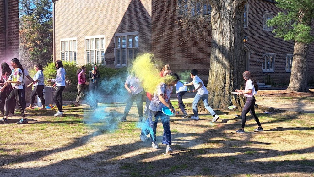 Students celebrate Holi by throwing powdered colors at one another in a friendly game on March 19 at the Westhampton Green.&nbsp;