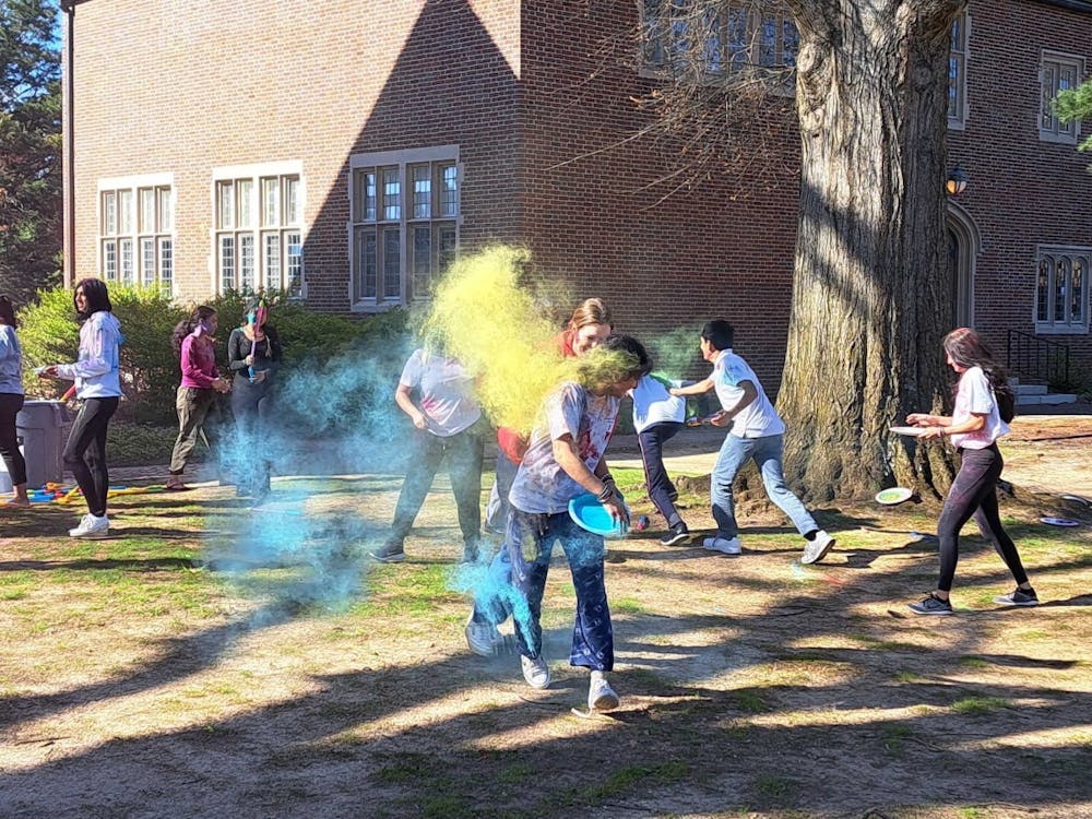 Students celebrate Holi by throwing powdered colors at one another in a friendly game on March 19 at the Westhampton Green. 