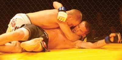 Brian Grimes (top) of Richmond applies a hold on Jarrod Bryant (bottom) also of Richmond. Grimes went on to win the match.