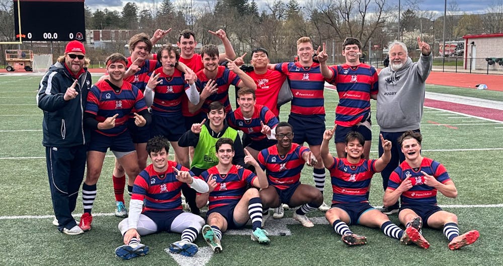 The men's club rugby team celebrates their April 6 win that earned them an automatic bid to the Collegiate Rugby Championship. Photo courtesy of Patrick Benner.