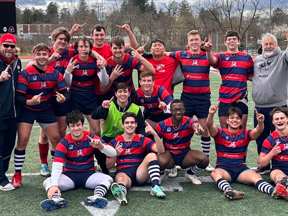 The men's club rugby team celebrates their April 6 win that earned them an automatic bid to the Collegiate Rugby Championship. Photo courtesy of Patrick Benner.