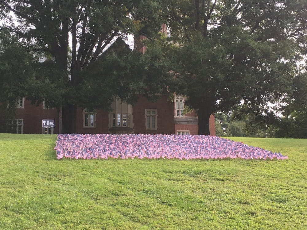 Members of College Republicans and College Democrats put out flags to honor each victim of 9/11 Monday morning.