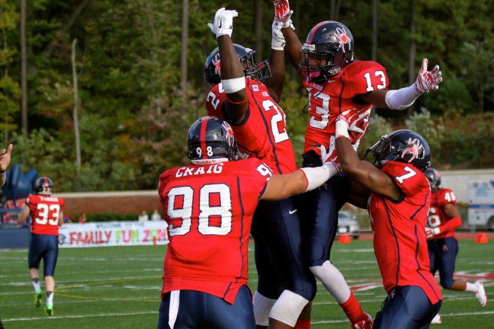 Defensive back David Jones #13 celebrates after recovering a Rhode Island fumble for the Spiders.
