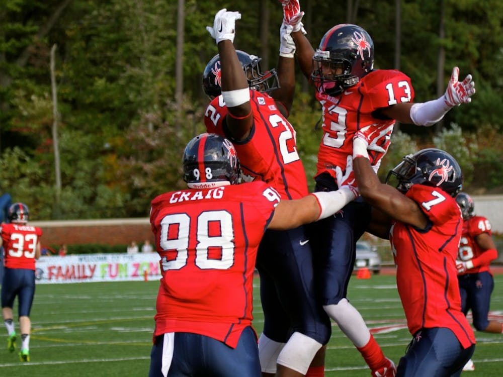 Defensive back David Jones #13 celebrates after recovering a Rhode Island fumble for the Spiders.