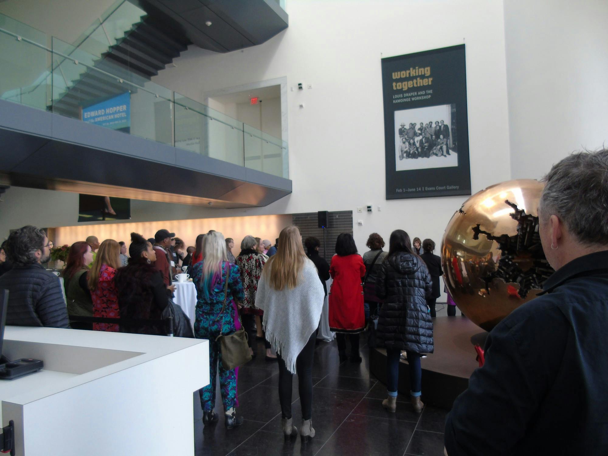 Onlookers stand at the opening of “Working Together: Louis Draper and the Kamoinge Workshop," a new exhibit at the Virginia Museum of Fine Arts. The exhibit opened on Feb. 1, 2020.