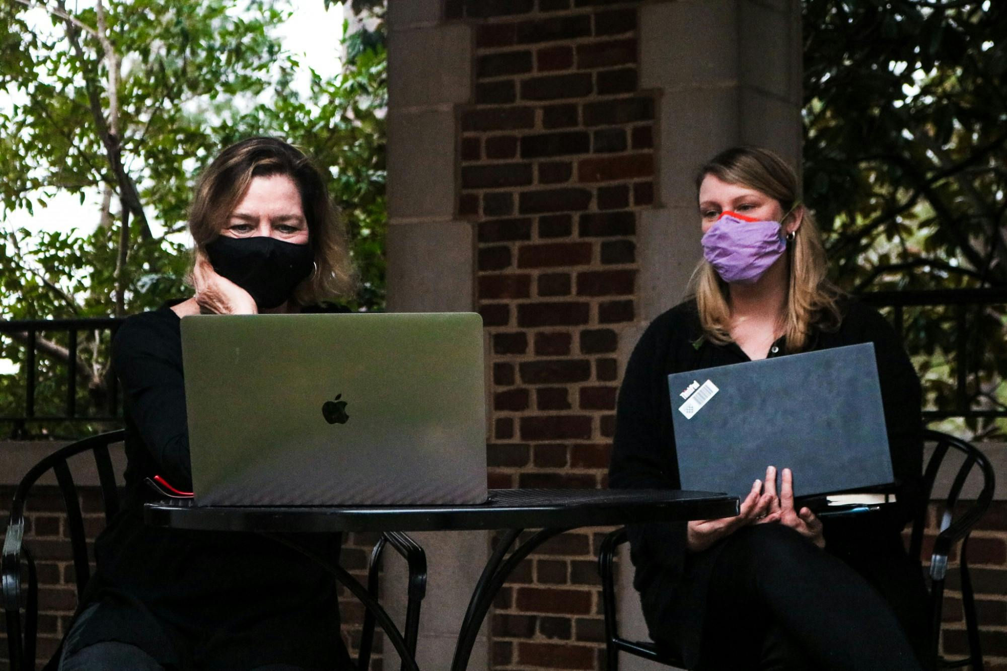 Two members of the community wearing black while watching the teach-in protest.