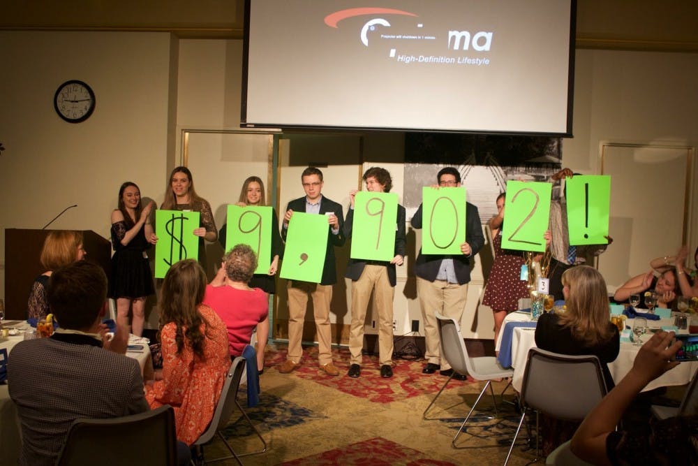 Student volunteers for Make the Magic reveal how much money was raised during the event.&nbsp;