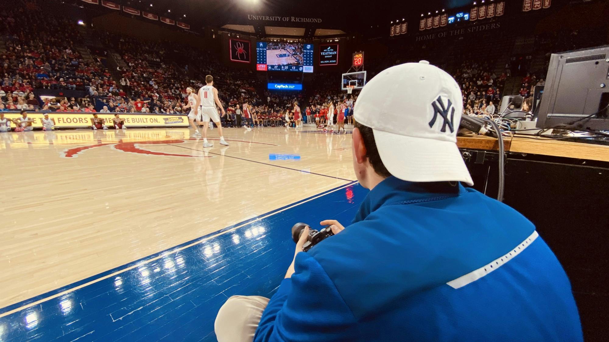 Kyle Gardner sitting courtside in the University of Richmond Robins Center during the Feb. 29 game against University of Massachusetts Amherst.