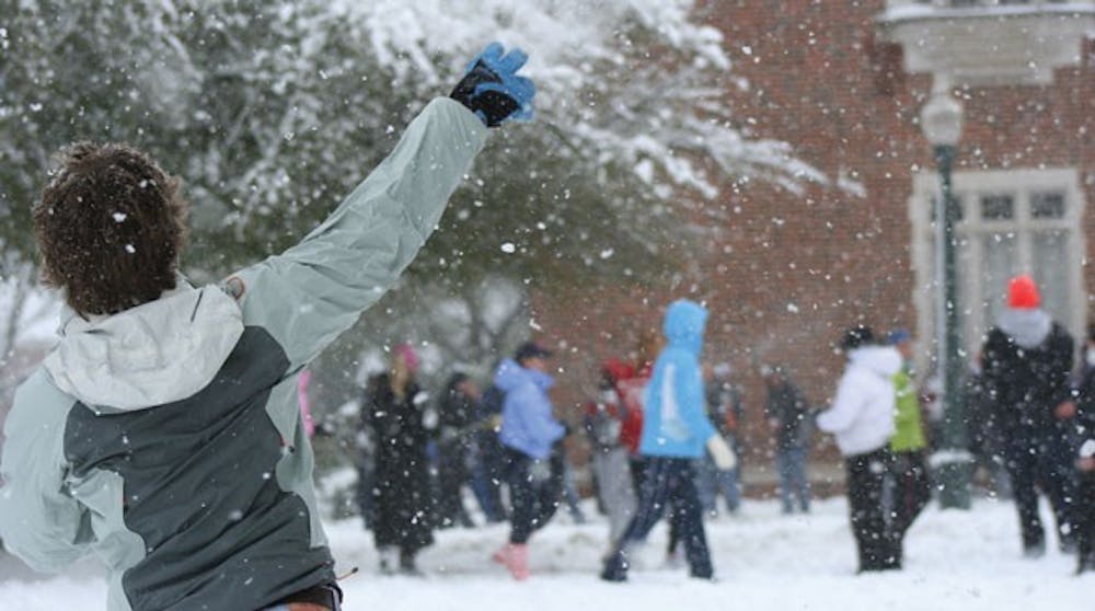 A student hurls a snowball at the crowd Monday afternoon on the Westhampton Green.