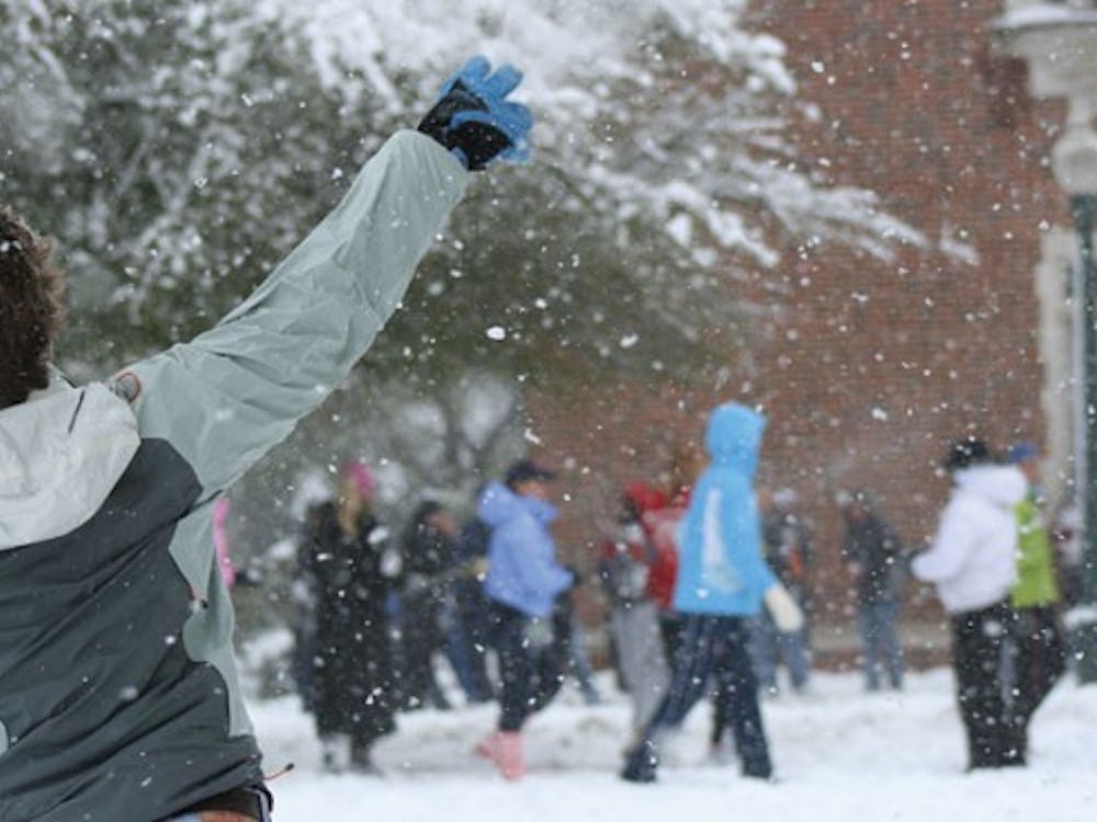 A student hurls a snowball at the crowd Monday afternoon on the Westhampton Green.