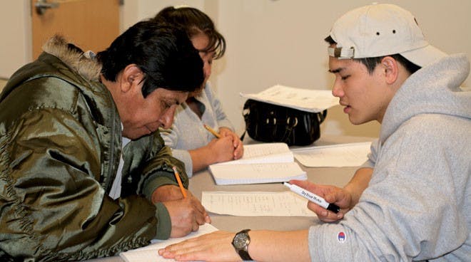 Russ Gong helps Arturo Martinez and Rasalienda Hatelpa with their english