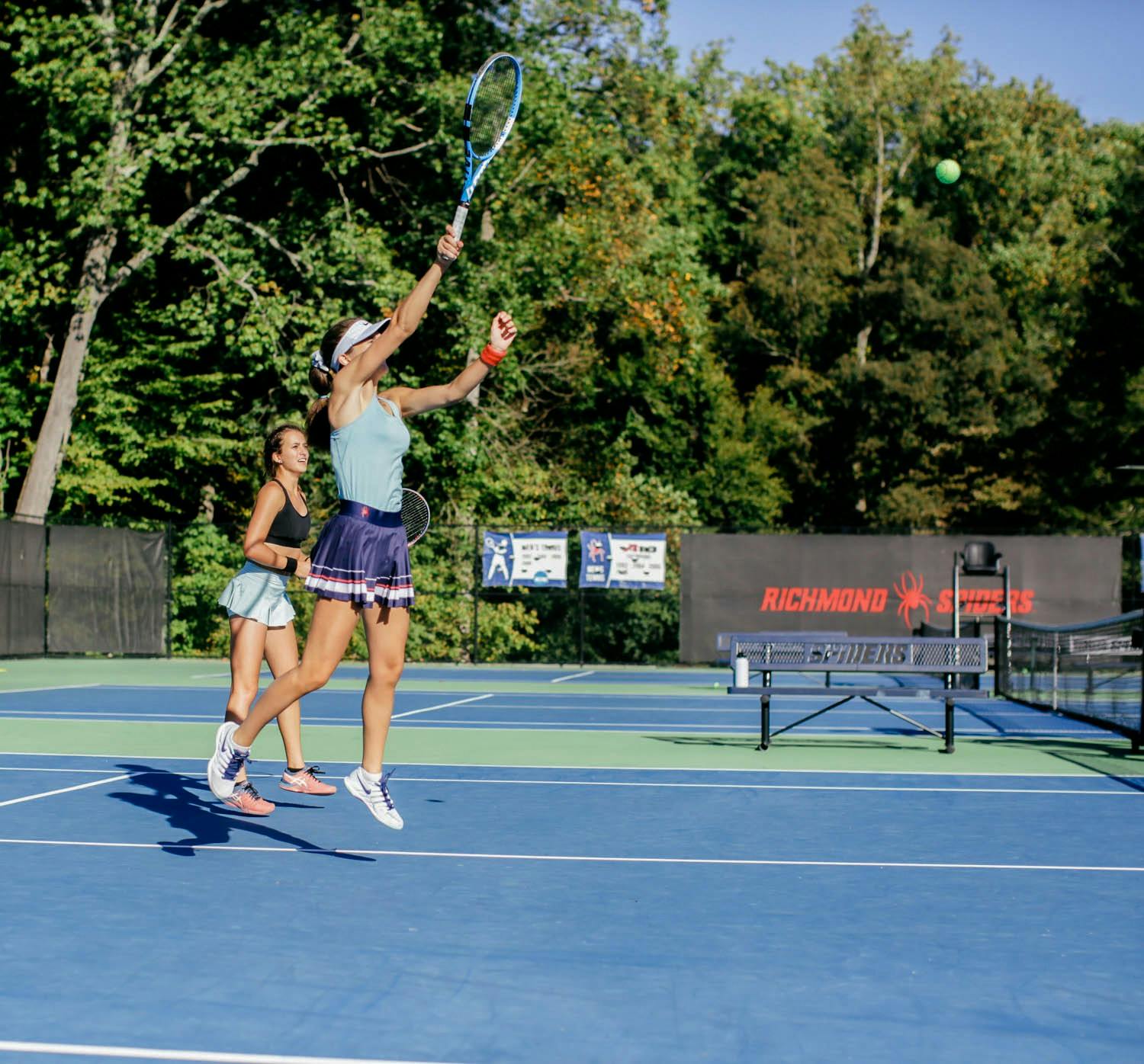&nbsp;Freshman Sara Salemyr fires a ball across the net during a doubles practice with sophomore Andrea Campodonico.&nbsp;
