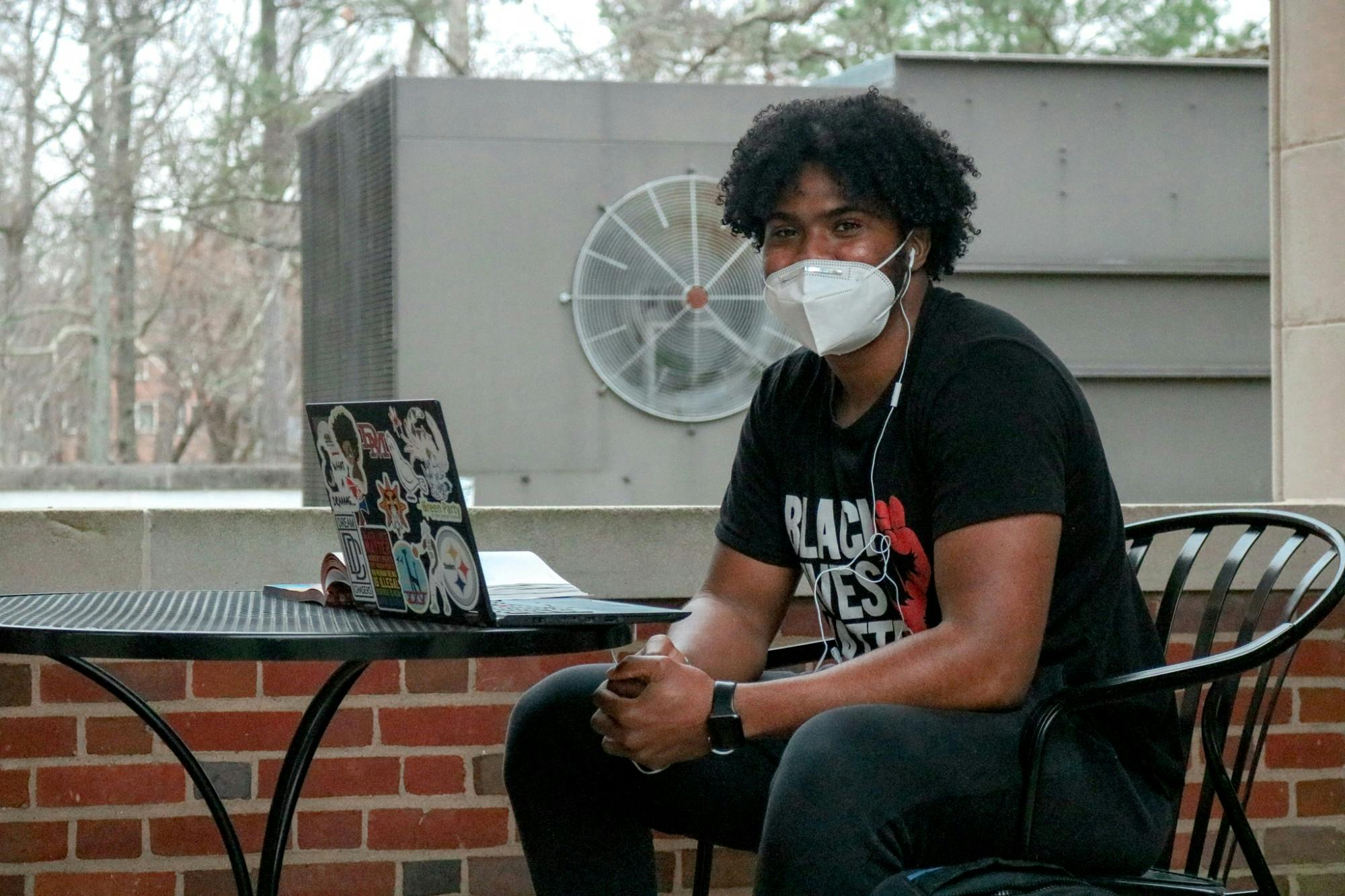 Senior Beau English watches the protest outside Richmond hall.