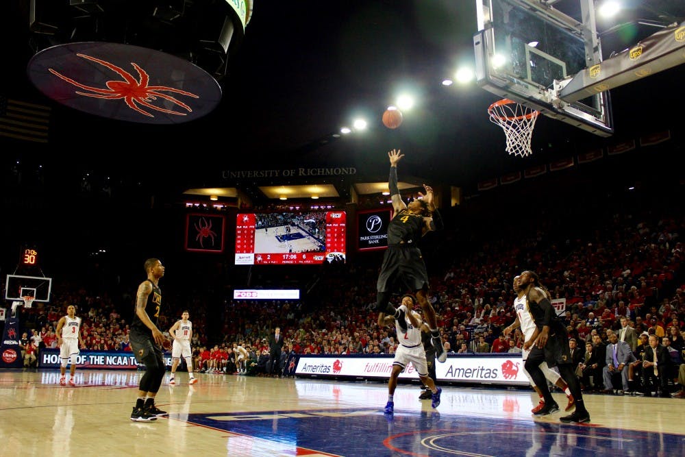 VCU forward Justin Tillman gets some height for a rebound in the first half of the game. Tillman finished the game with 8 total points and 6 rebounds.