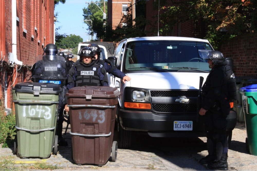 Virginia State Police adorn riot gear and cordon off streets in preparation for the rally.