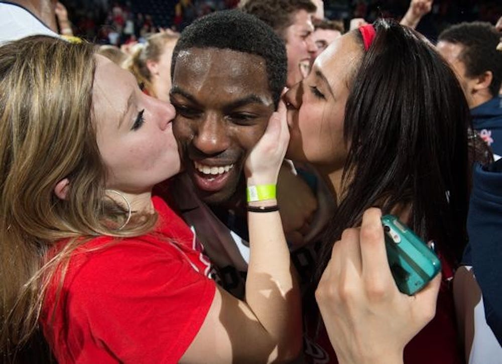 <p>Kendall Anthony enjoys the company of his fellow students after defeating VCU in double overtime. Photo courtesy of Richmond Basketball. </p>