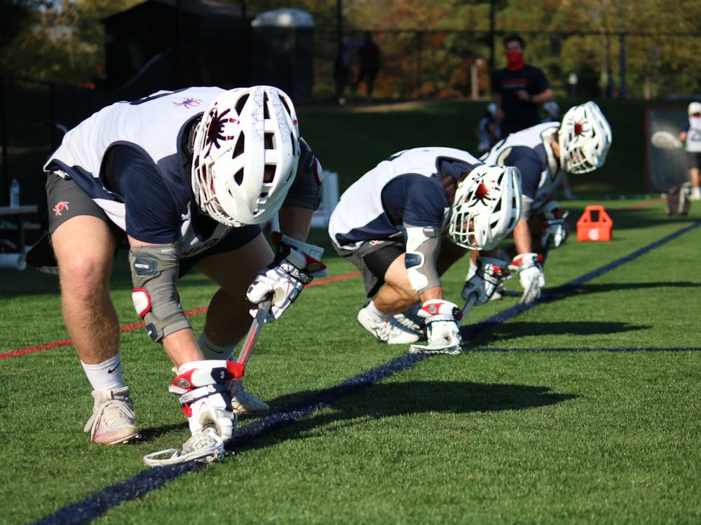 Players on the University of Richmond men's lacrosse team prepare for practice.