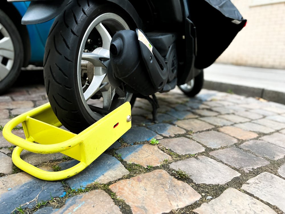 <p>A vehicle that has a wheel lock for more than 10 days may be towed off campus at the owner’s expense, according to the policy. Photo courtesy Jan Antonin Kolar / Unsplash.</p>