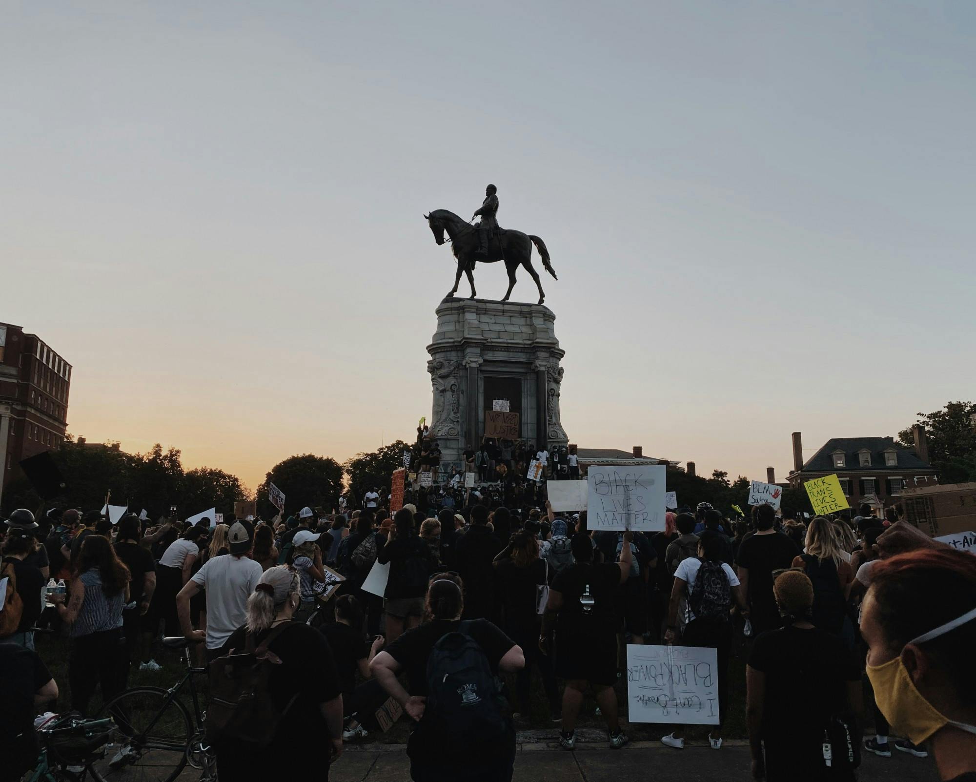 Protesters gather on June 2 around the Robert E. Lee statue on Monument Avenue, where demonstrators stand on the statue, which is covered with graffiti.&nbsp;