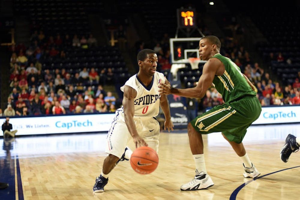 <p>Richmond point guard Kendall Anthony drives toward the basket past the William and Mary defense. Photo courtesy of Richmond Athletics.</p>