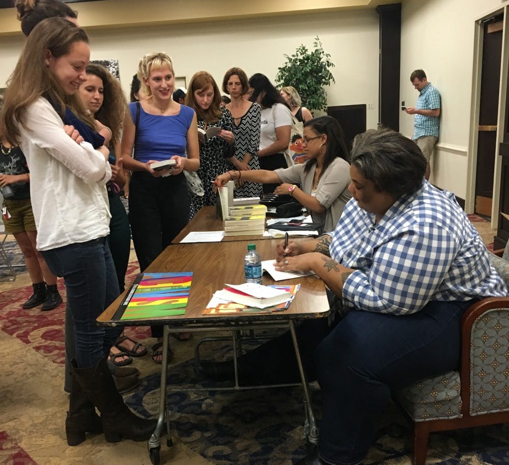 Roxane Gay signs autographs in the Alice Haynes Room.
