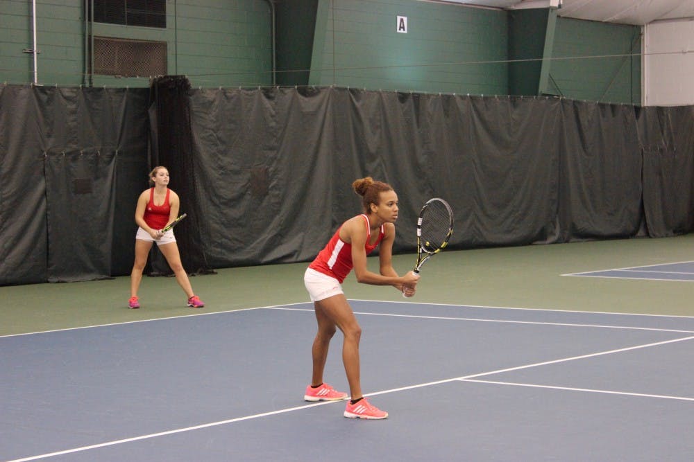 Richmond freshmen Kiana Marshall and Lyndell Giffenig prepare for a long match against Navy's Catalina Rico and Aimee Dervishian.