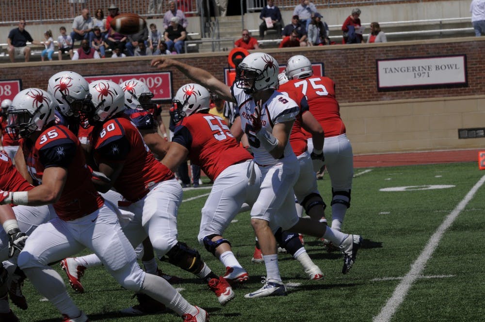 Starting quarterback Kyle Lauletta launches a ball over the offensive line during the first half of the annual spring game that took place on Saturday in the Robins Center | Photo courtesy of Richmond Athletics