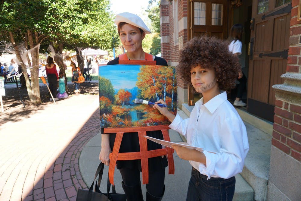 Laura Knouse, associate professor of psychology, and her son, Liam, dressed as Bob Ross and his painting. 