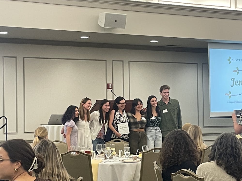 <p>Jenifer Sevin, professor of biology, poses with student after receiving a award recognizing her&nbsp;</p>