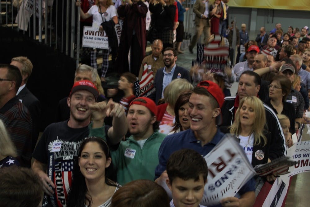 <p>Young Trump supporters walk around at a rally in Richmond last year.&nbsp;</p>