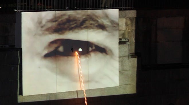 Two eyes programmed to mimic video from an actual conversation it on either side of the Haxall Canal in historic Tredegar. They are connected by this (wire?).