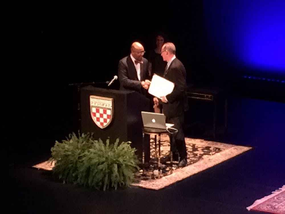 <p>Paul Farmer accepts an honorary doctorate degree from President Ronald Crutcher.</p>